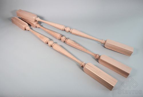 Three turned wooden balusters with square mounting bases