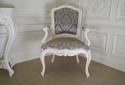 Designer chair with carved wood and elegant pattern
