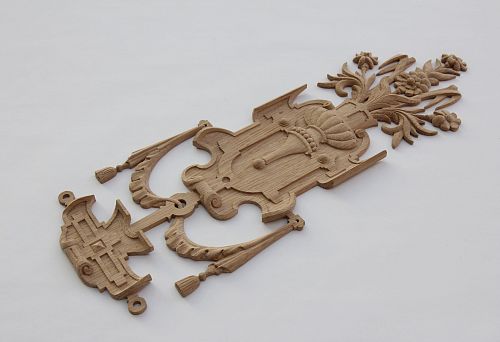 Carved decorative wooden element with floral ornament &mdash; example of unique decoration for furniture and interior.