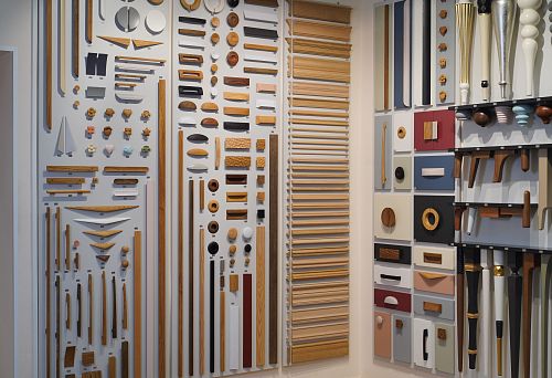 Exhibition stand featuring diverse wooden samples and decorative elements of various shapes and shades.