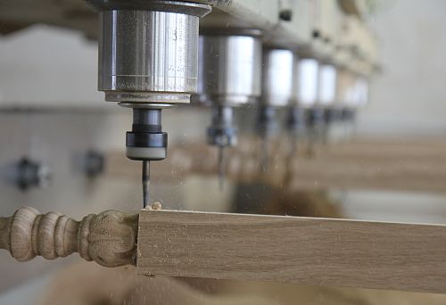 Carving wood using a CNC machine at a furniture factory