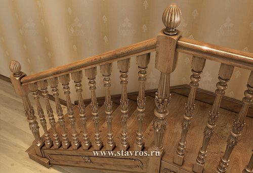 Carved balusters from solid wood and classic railings on the turn of the staircase landing