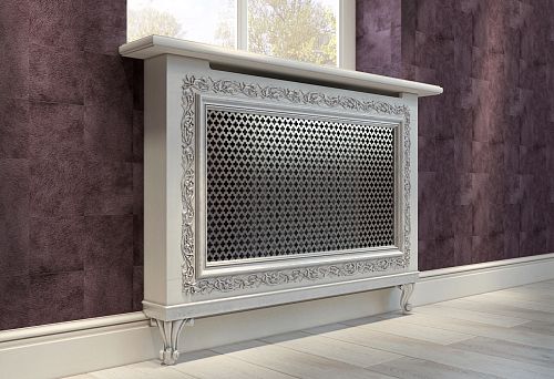 A stylish light radiator screen with carved decoration against wooden walls
