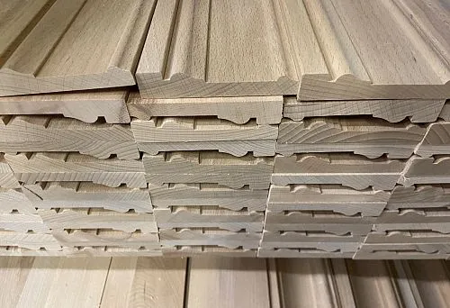 Stack of wooden and MDF skirting boards 80 mm high, stacked on top of each other
