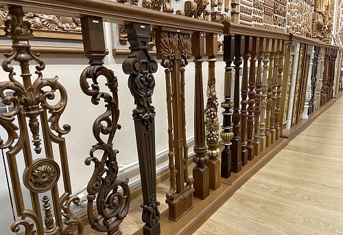 Various carved wooden balusters and posts of the balustrade with elegant carving and decorative elements