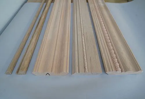 Decorative wooden moldings and cornices for ceiling, made from natural solid wood.