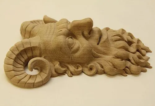 Carved wooden figure of a mythological character with horns and thick curly hair.
