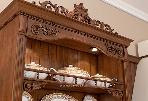 Fragment of a wooden cabinet with carved decoration, stained or lacquered, classic handcrafted ornament