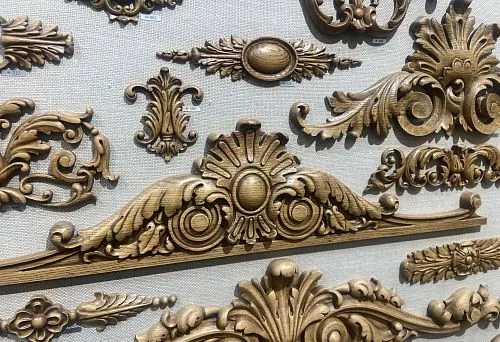 Decorative carved wooden ornaments in classic style, crafted with fine detailing.
