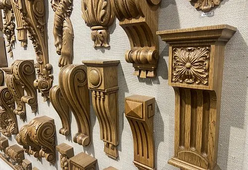 Set of decorative wooden brackets with carved elements, used as supports for shelves.