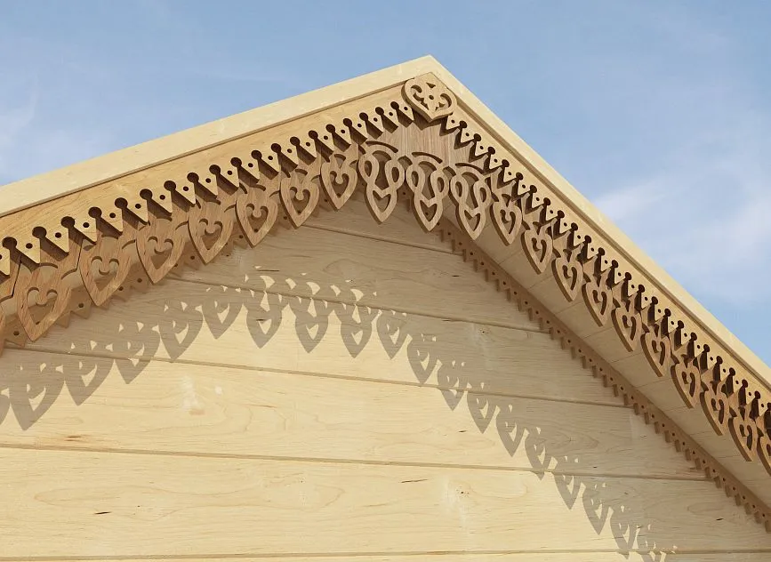 Decorative wooden gable with delicate carving in the shape of hearts.