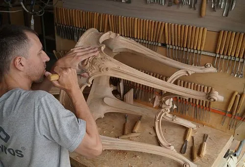 Handcrafted custom furniture &ndash; carved coffee table in production.