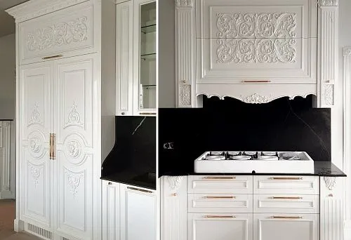 Classic white kitchen with tall carved facades, decorative elements, and built-in gas stove, made of wood.