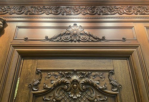 Decorative wooden doorway framing with carved ornament in classical style