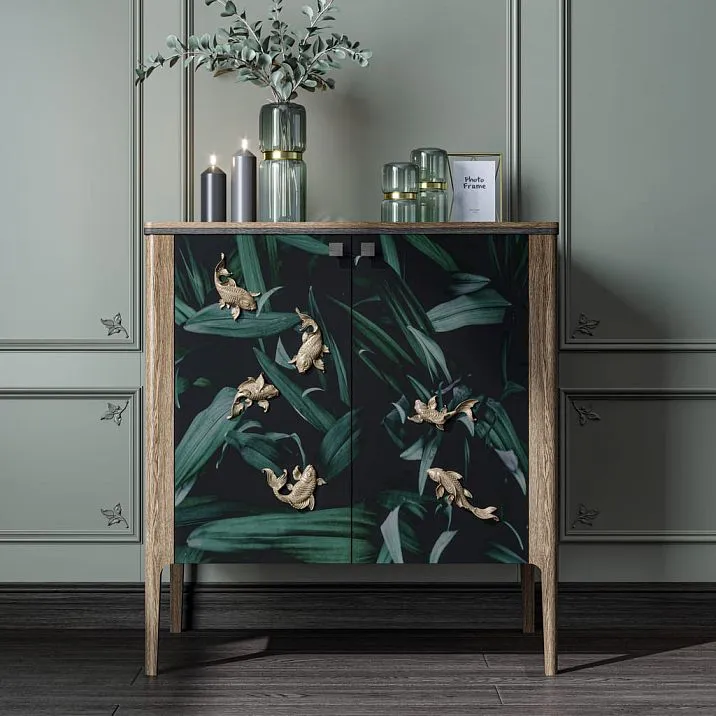 Stylish chest of drawers with polyurethane relief decoration in the form of golden fish.