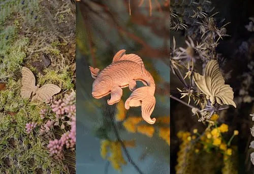 A pair of wooden fish cut from solid wood, emphasizing natural motifs in interior design