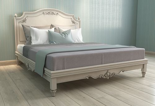 Light wooden bed with carved decorative elements