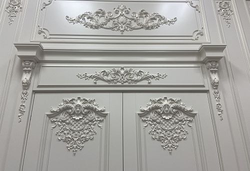 Snow-white sandrok cornice with decorative molded ornament and elegant architectural details in interior