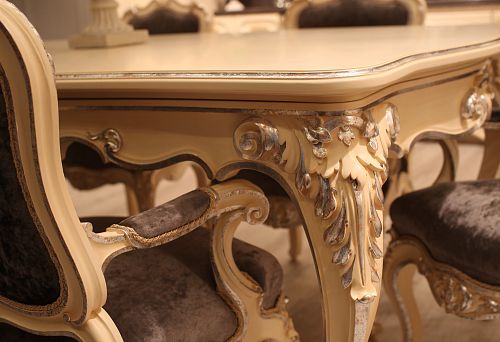 Elegant carved table base with silver decoration and smooth lines in classic style