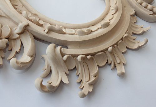 Close-up of carved wooden decorative element, expressive hand-carved motifs with plant patterns for modern and classic interiors