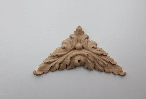Carved wooden applique in classic style with leaf and scroll ornament.