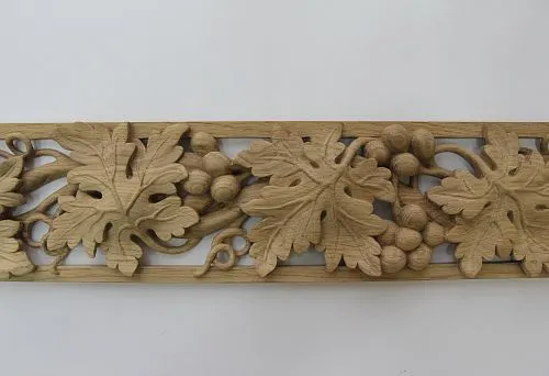 Carved wooden panel with oak leaf and acorn pattern.