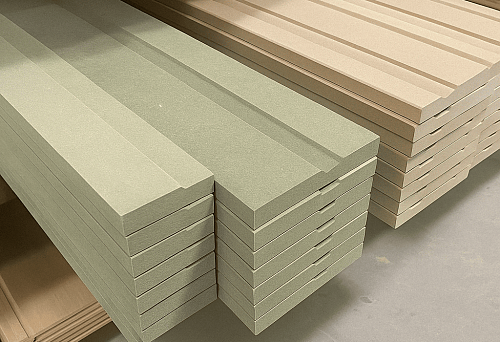 Smooth straight wooden skirting in green and beige colors &mdash; side view