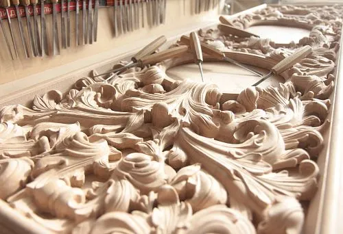 Detailed carved wooden decorative element with elegant scrolls and three-dimensional forms