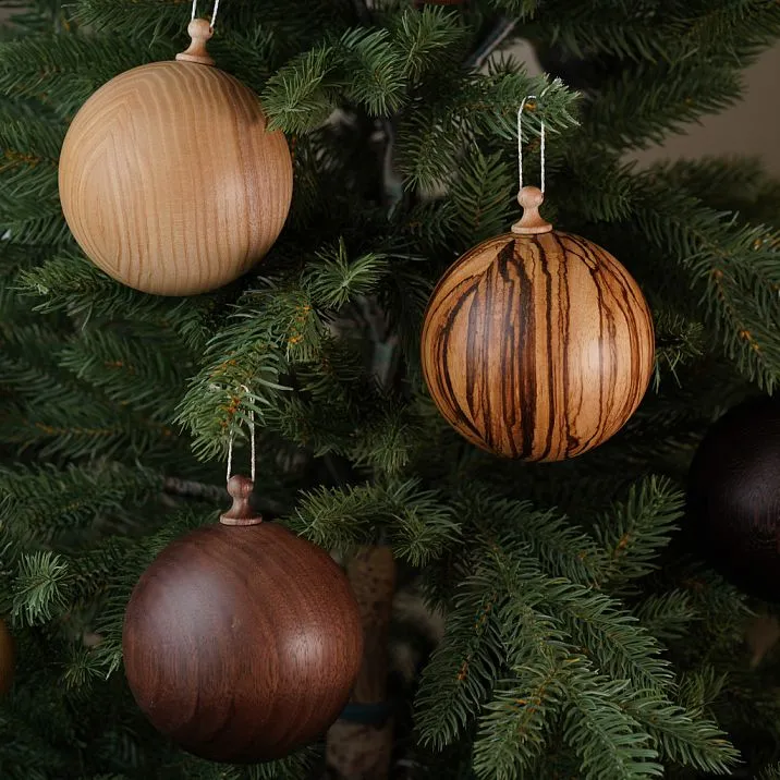 Christmas balls SUV-002 made of solid wood for a festive tree: natural ash, exotic zebrawood, and warm walnut