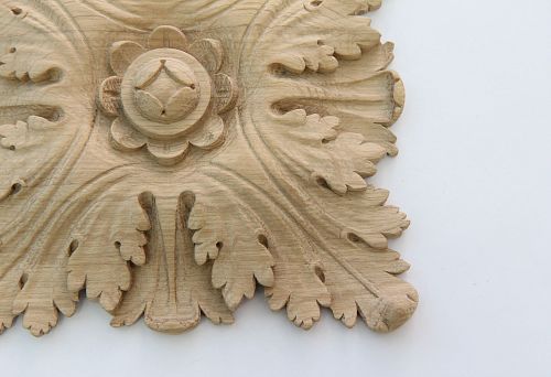 Carved wooden decoration close-up &mdash; carved applique with leaves and flower, handmade, SPb