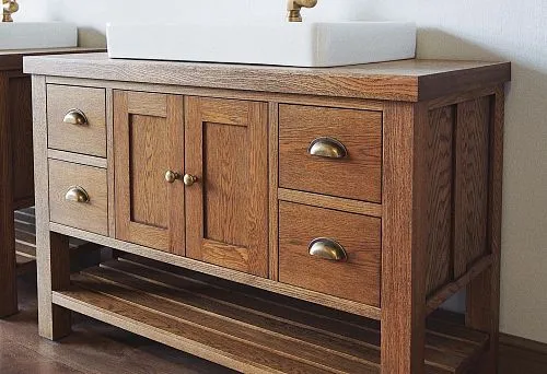 Stylish Cabinet Made of Natural Wood with Brass Handles and Sink.
