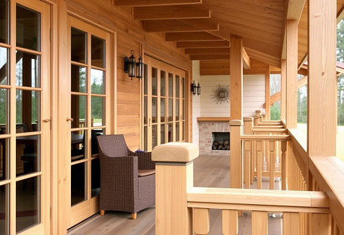 Wooden balusters and railing on a spacious veranda of a private house in Saratov