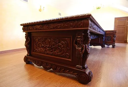 Luxurious carved wooden table with decorative elements, crafted in a classic style.