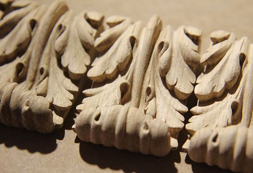 Carved oak element with fine detailing, demonstrating high precision of furniture manufacturing technology