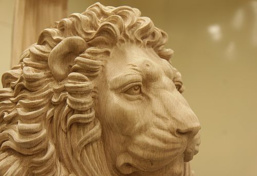 Close-up of carved wooden lion head, showcasing handcrafted skill