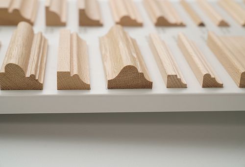 Various Profiles of Solid Wood Stair Stringers on Display Stand for Demonstrating Forms and Cross-Sections