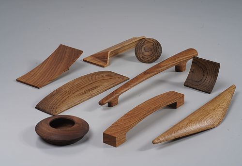 Modern wooden furniture handles in various shapes and shades &mdash; hardware assortment for furniture