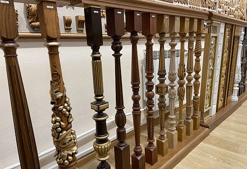 Various turned balusters of different wood species with carved and decorative elements