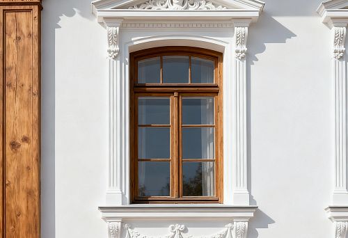 Facade decor for window finishing with classical pediment and decorative elements