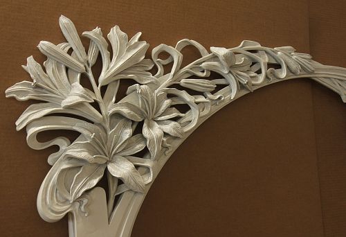 Wooden bas-relief with elegant floral ornament, covered with silver patina