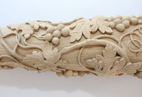 Complex carved detail from solid oak with grape leaves and clusters