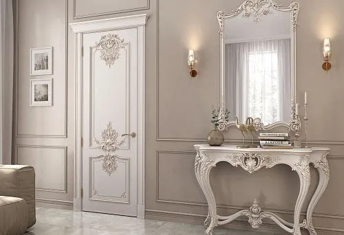 Elegant carved console table with large mirror and decorative door in classic interior