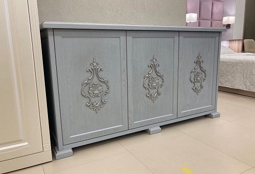 Three-door cabinet, light gray, with classic carved appliqu&eacute;s in the central part of each door