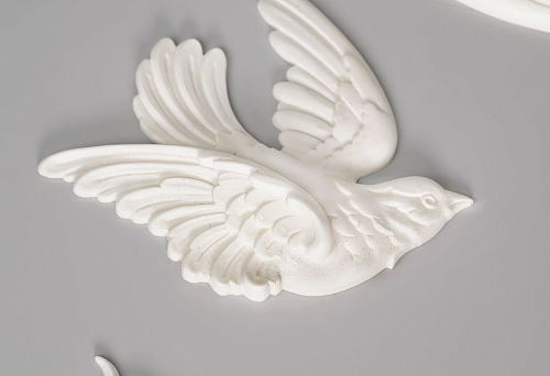 White polyurethane ceiling molding &mdash; a decorative bird with outstretched wings and botanical ornament on a gray background