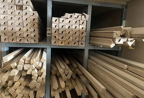 Set of wooden baseboards and moldings, arranged in storage compartments