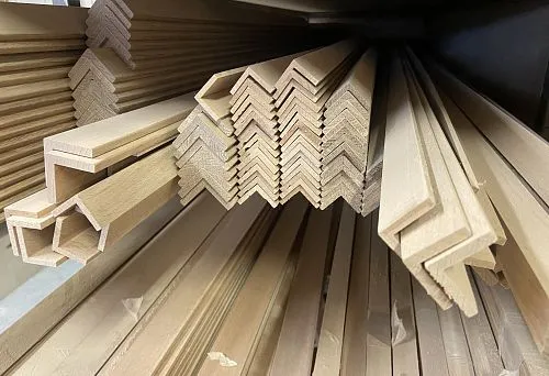 Stacks of carefully processed wooden profiles and solid beech lumber stock on the warehouse