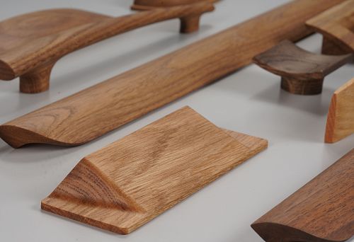 Modern wooden furniture handles in various shapes and shades &mdash; hardware assortment