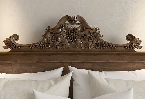 Carved wooden headboard with grapevine ornament &mdash; an accent in classic-style interiors