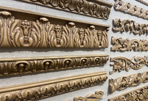 Carved wooden baseboards with classic ornamentation, available in various sizes