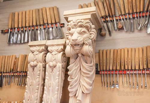 Carved Wooden Brackets and Capitals with Lion Motifs in the STAVROS Workshop Against the Background of Wood Carver's Tools